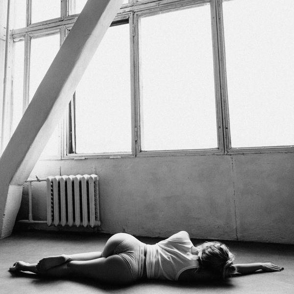 Woman in a calm yoga pose in a modern studio.
